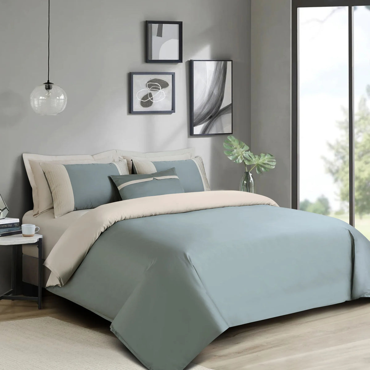 Bedroom with olive green bedding and neutral pillows, featuring a side table and decor.