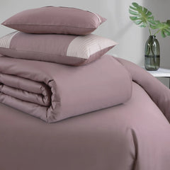 Wine bedding set with pillows on a bed in a room setting.