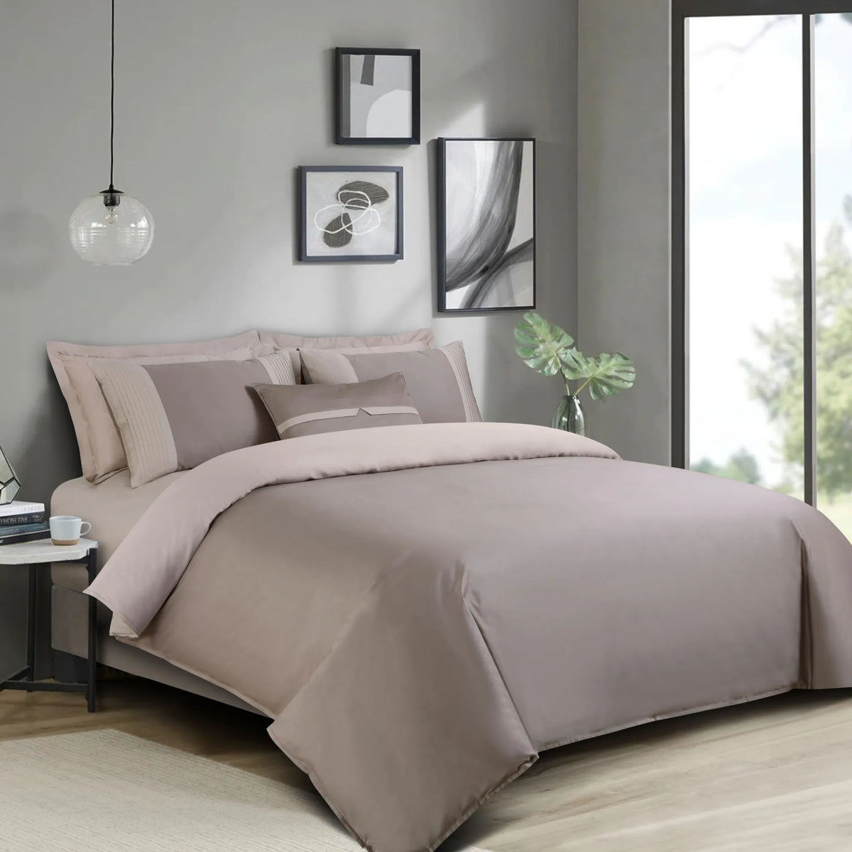 Neatly made bed with taupe brown bedding in a modern bedroom setting.
