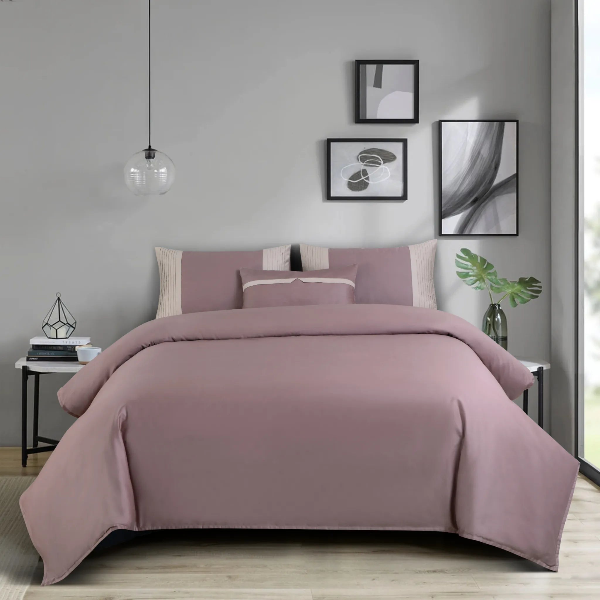 Wine bedding set on a bed in a bedroom with gray walls and decorative elements.