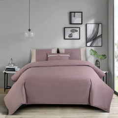 Wine bedding set on a bed in a bedroom with gray walls and decorative elements.